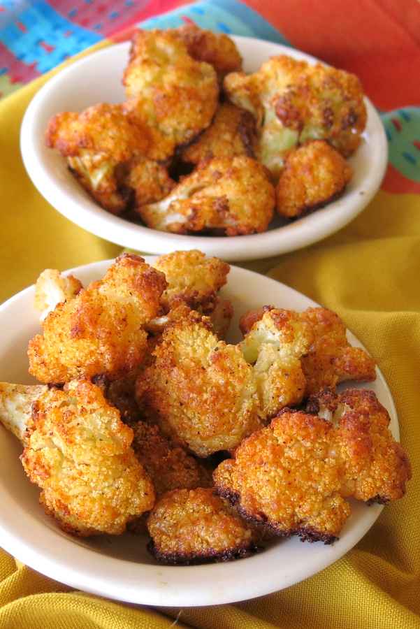 Crispy Cauliflower Florets in a bowl with another bowl with more behind it.