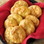A basked of low-carb cloud bread made with ricotta in a basket lined with a red cloth.