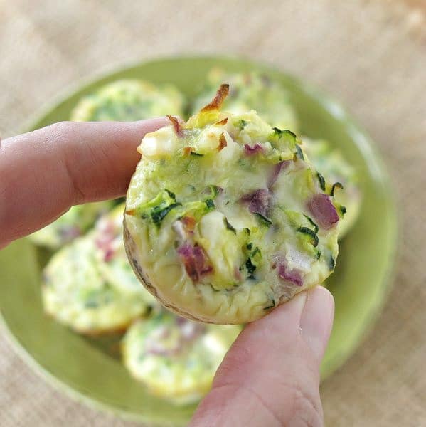 Fingers holding Zucchini Egg Mini Muffins 