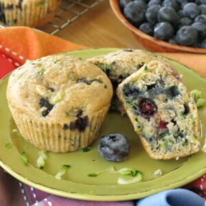 2 Zucchini Blueberry Muffins on plate with 1 cut in half