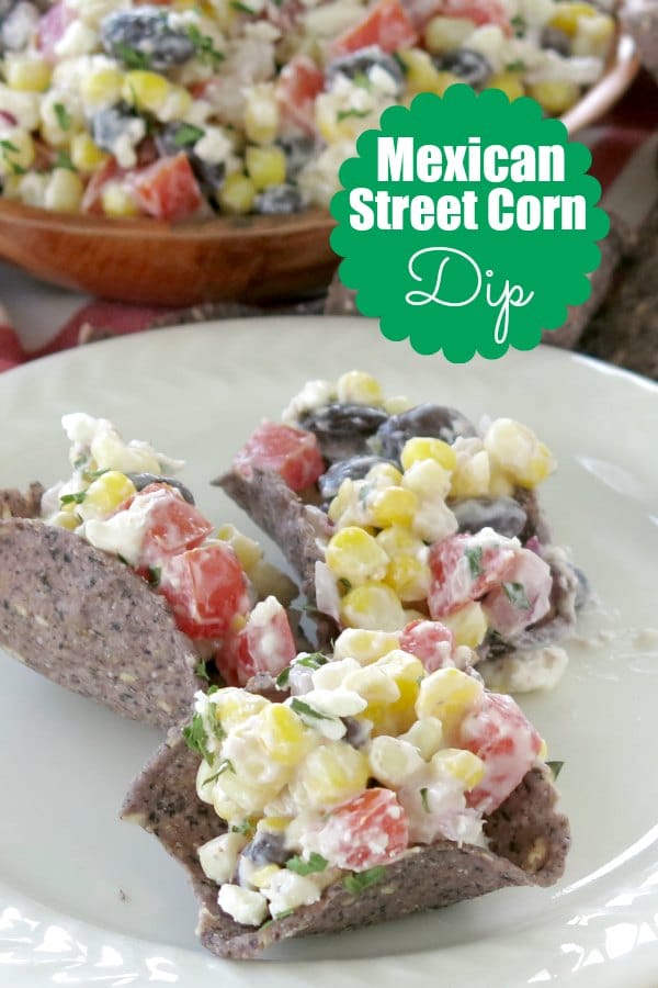 Mexican Street Corn Dip combines fresh corn, black beans, tomatoes and red onion in a creamy dressing with a bit of heat. Top it off with feta cheese and you'll be hooked too! #streetcorn #mexicanfood #corn #dip #appetizer #meatless #vegetarian