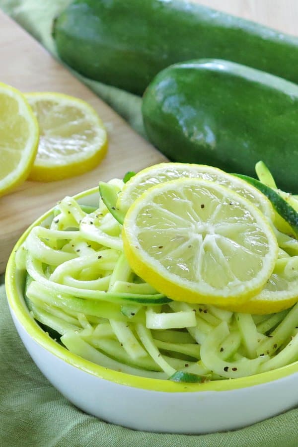 Lemon Garlic Zoodles in bowl with lemon slices on top