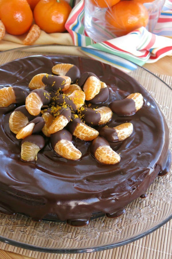 Orange Chocolate Flourless Cake topped with chocolate dipped mandarin oranges