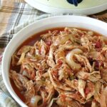 Healthy Salsa Chicken in serving dish with crock-pot in the background
