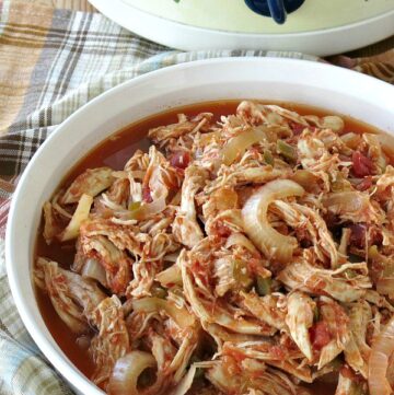 Healthy Salsa Chicken in serving dish with crock-pot in the background