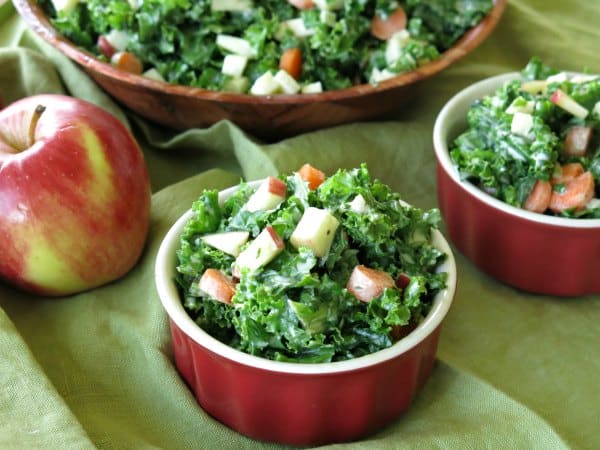 Kale and Apple Salad in small bowl with large bowl behind it