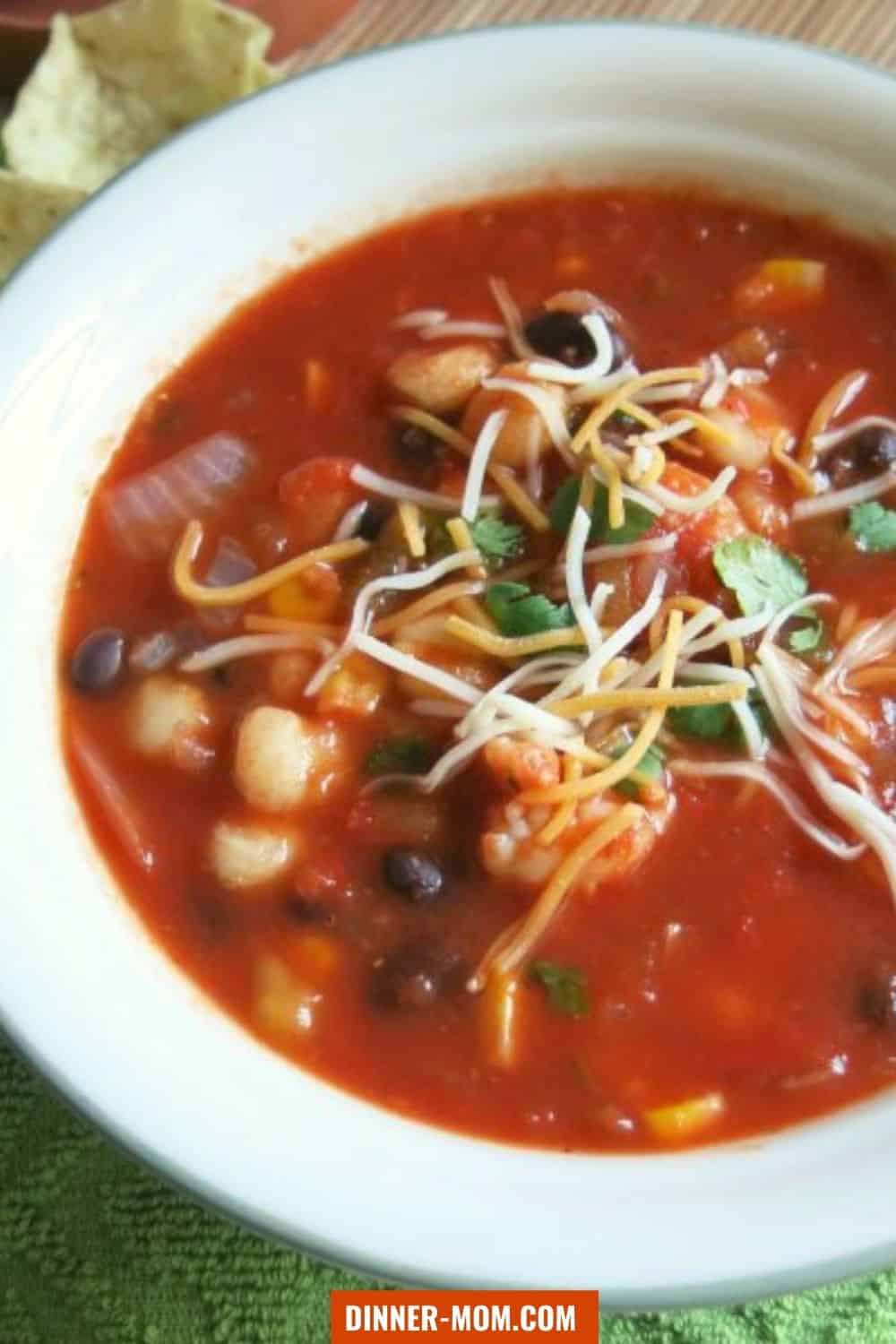 bowl of shrimp tortilla soup garnsihed with cheese and cilantro