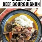 Crock-pot beef bourguignon on a plate with mashed potatoes.