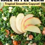 Tropical Smoothie kale apple slaw in a brown bowl with apple slices on top.