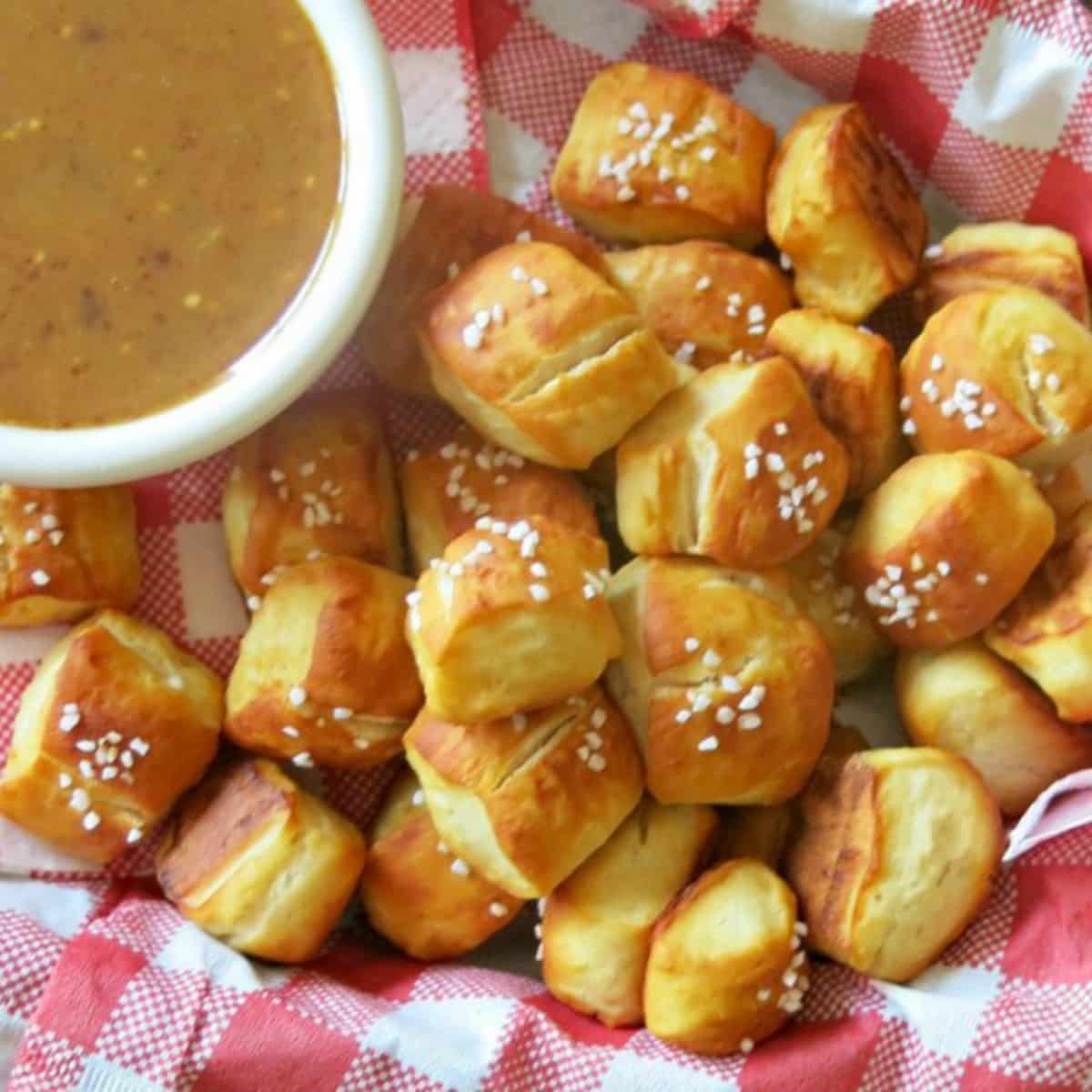 Homemade Pretzel Bites in basket with dipping sauce.