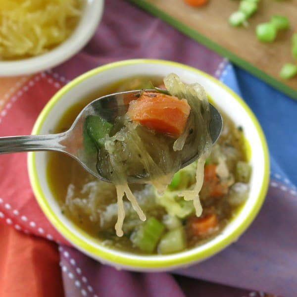 Spoon lifting soup from bowl