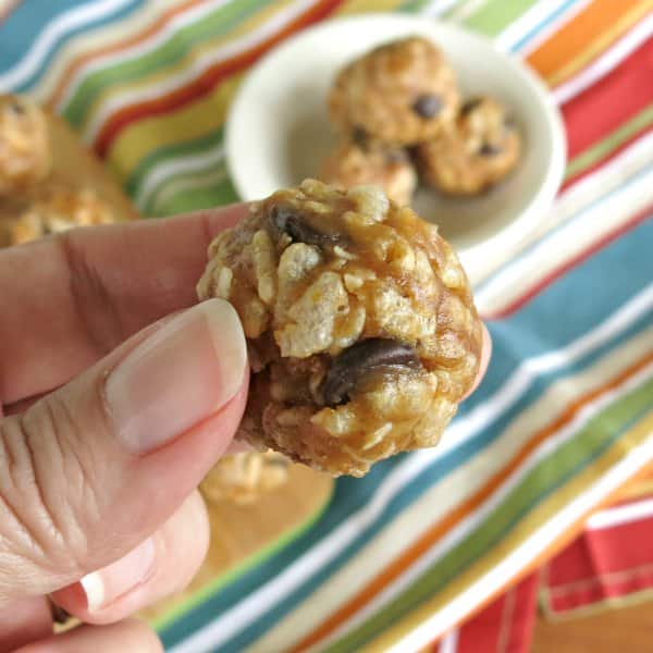 Fingers holding an Energy Ball with Puffed Rice Cereal