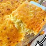 Serving of spaghetti squash au gratin being lifted out of casserole dish.