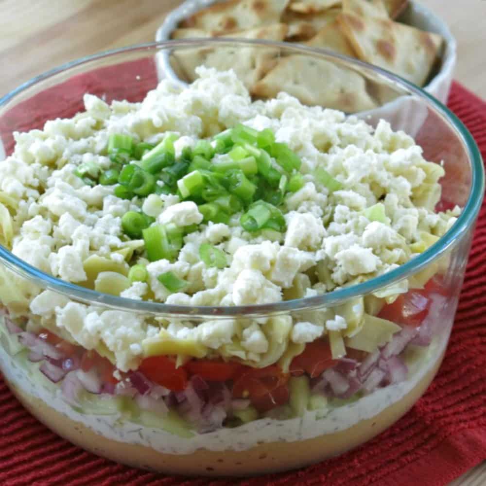 Greek Layered Dip with Tzatziki and other layers showing