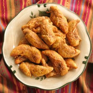 Baked Paprika Parmesan Chicken Tenders layered on a plate.