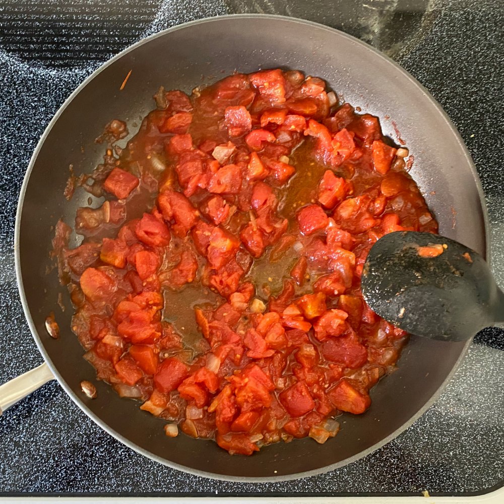 Tomato reduction in a large skillet.