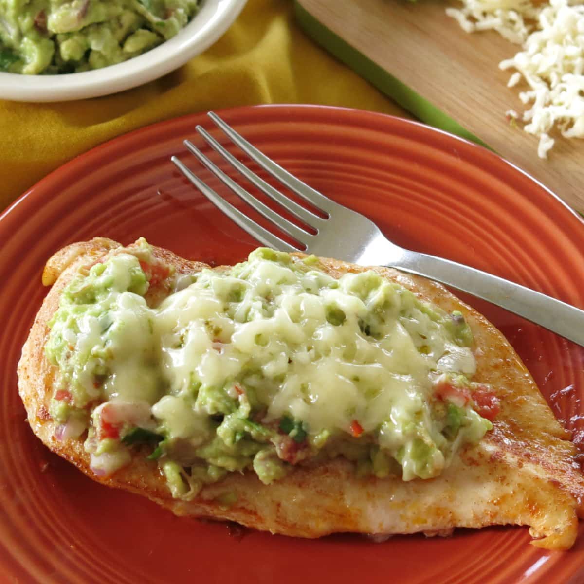 Guacamole Chicken on a plate with fork.