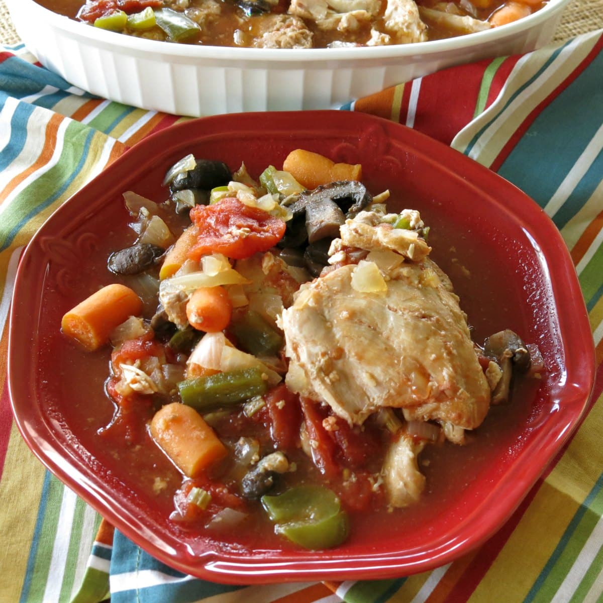 Slow Cooker Chicken and Stewed Tomatoes, carrots, peppers and onions on a plate.