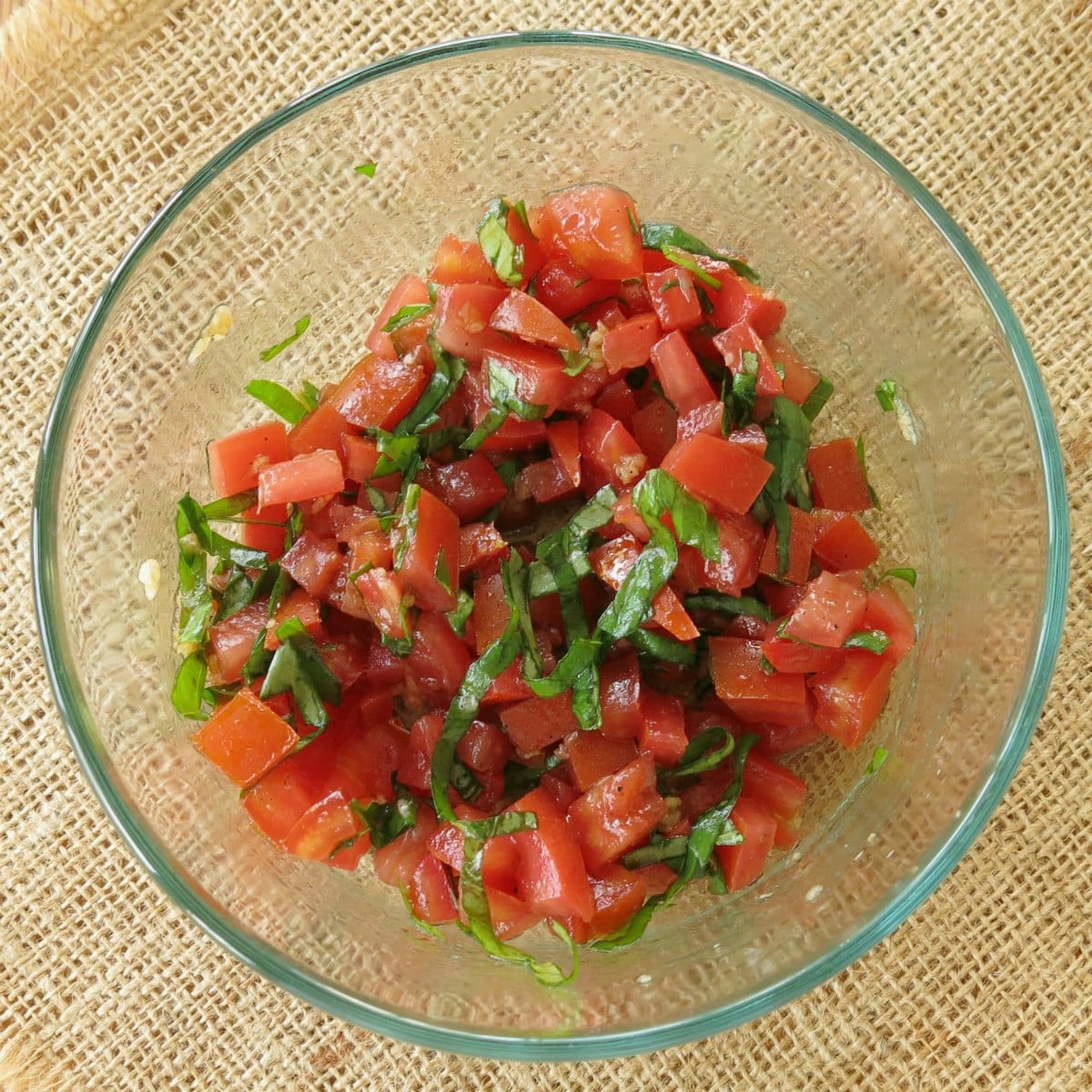 Homemade tomato bruschetta in a glass bowl.