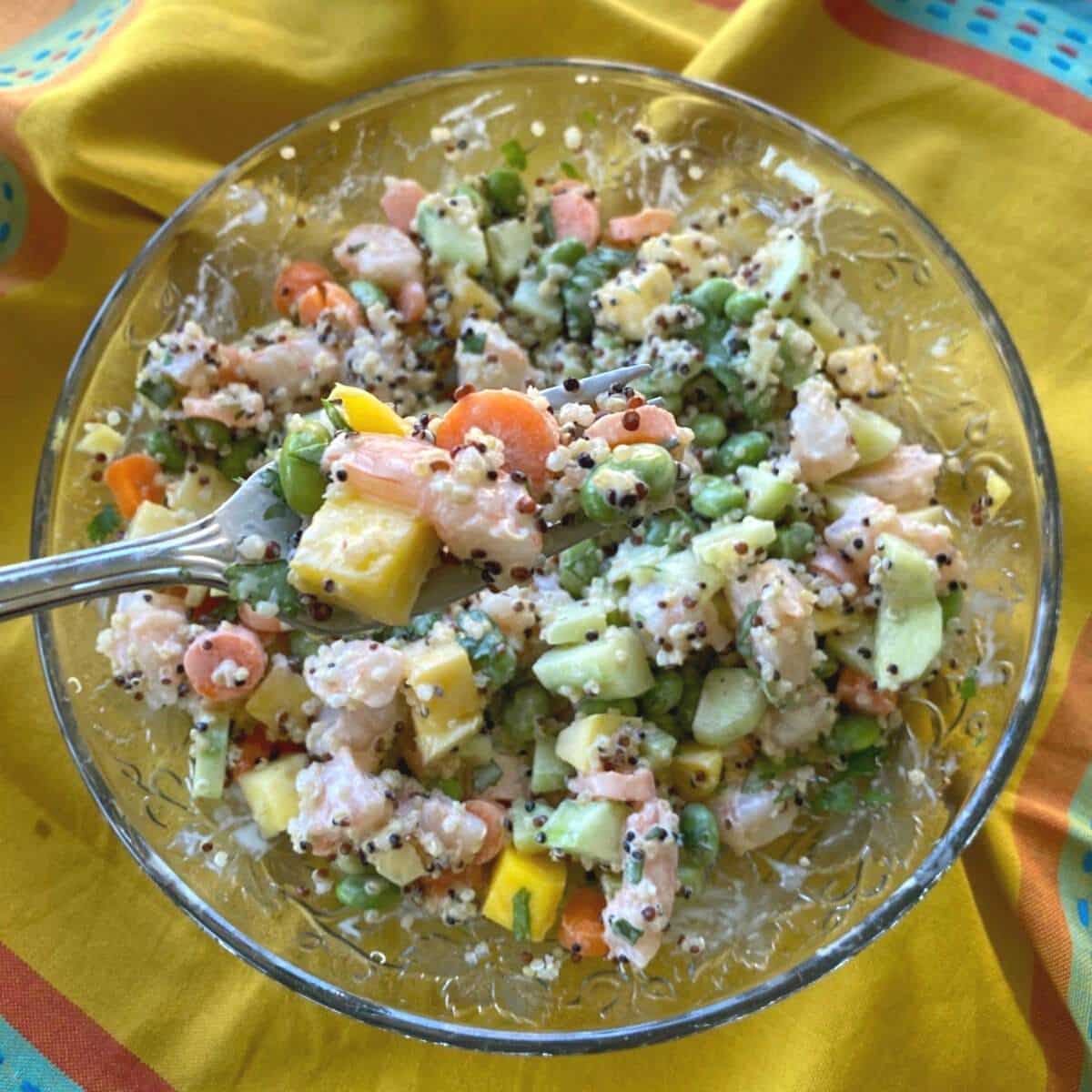 Shrimp Poke bowl with creamy poke sauce with a bite being taken out with a fork.