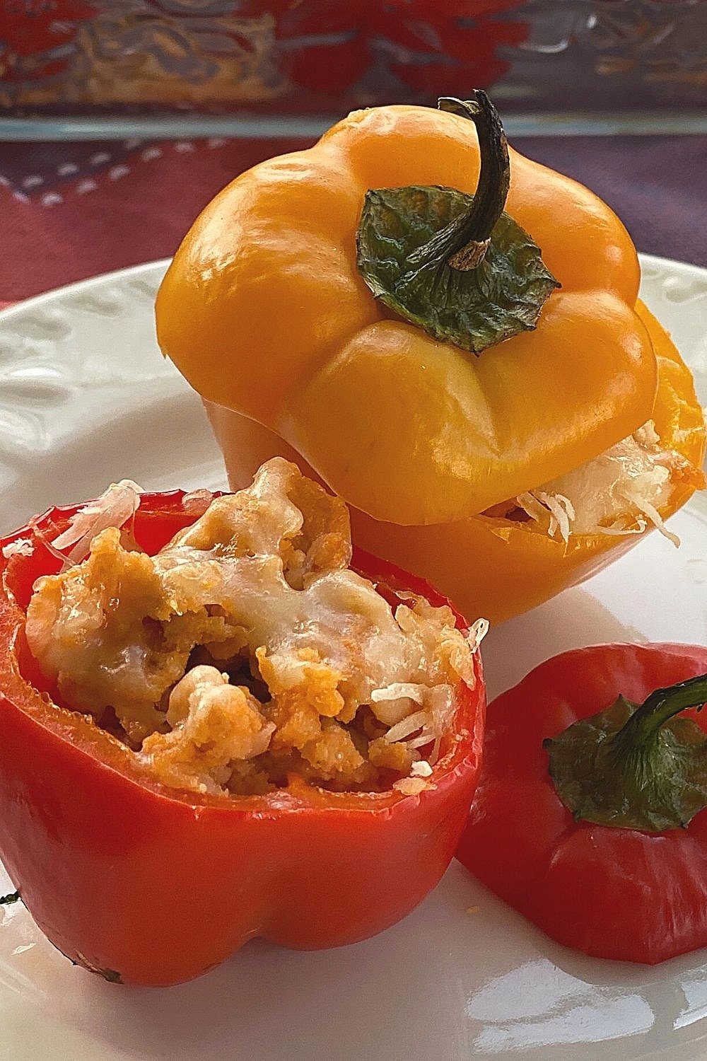 Red and Orange bell peppers stuffed with chicken meatloaf.