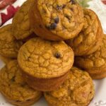 Stack of Healthy Greek Yogurt Pumpkin Muffins on a plate.