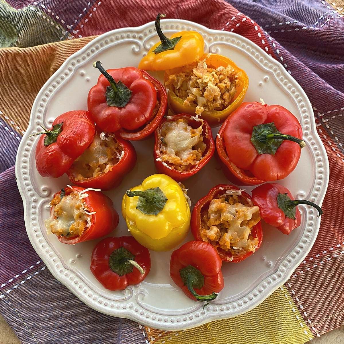 Plate of cooked baby bell peppers stuffed with leftover meatloaf.