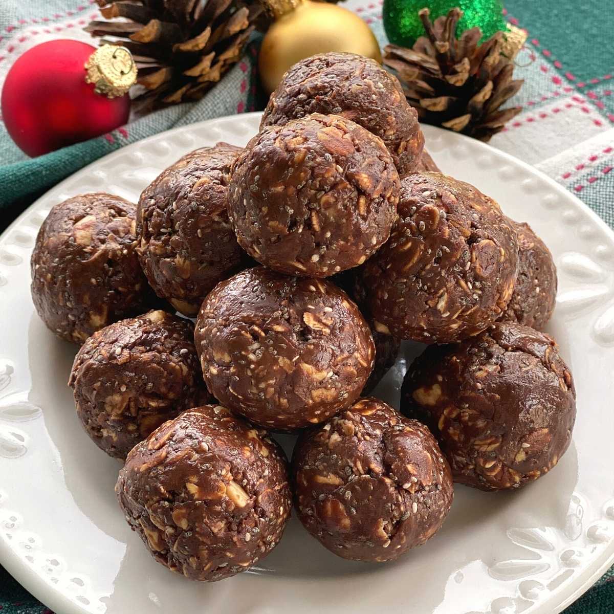 Plate of chocolate bliss balls made with hot honey, almond butter and chia seeds.