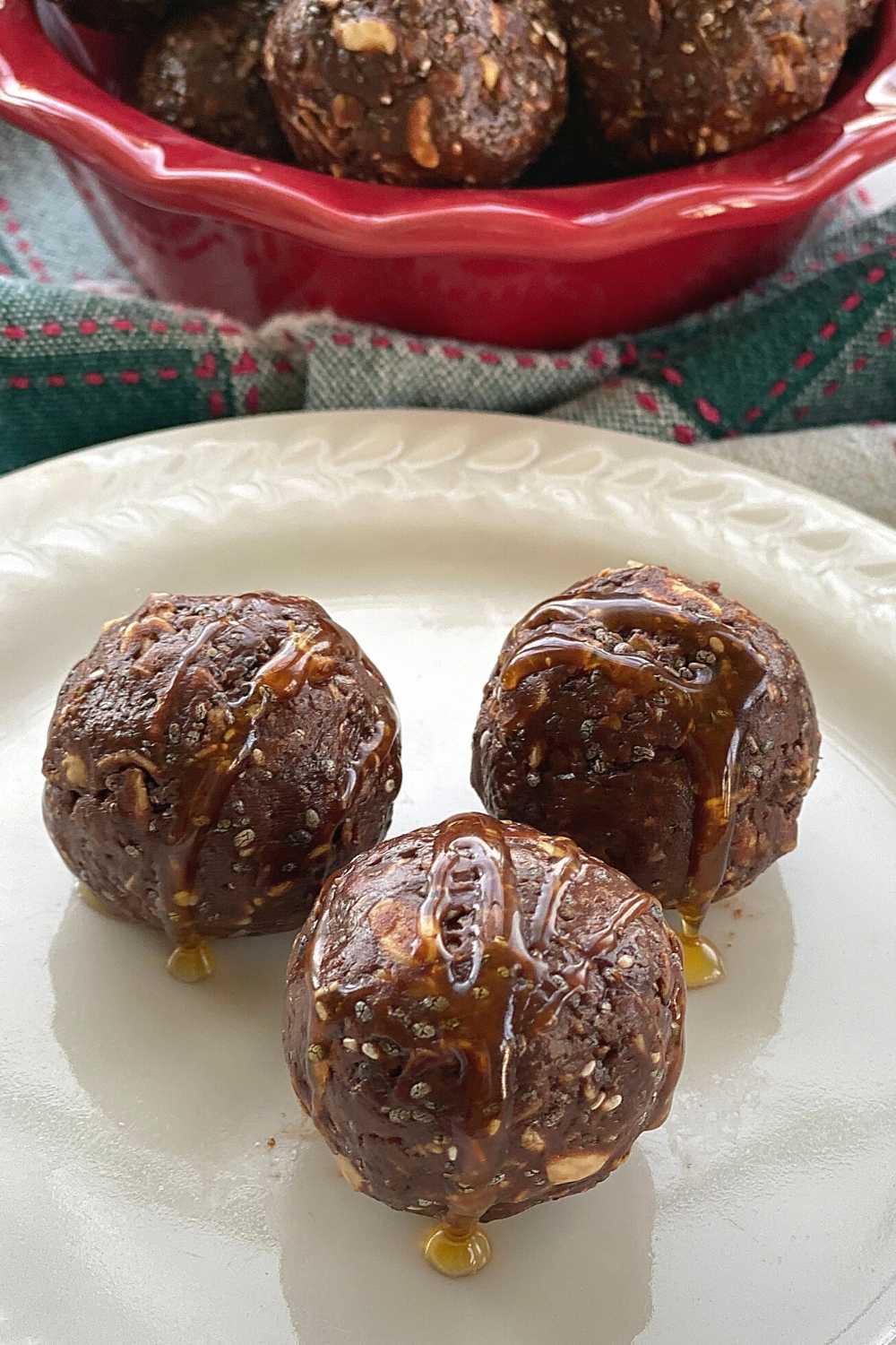 3 chocolate balls on plate drizzled with extra hot honey.