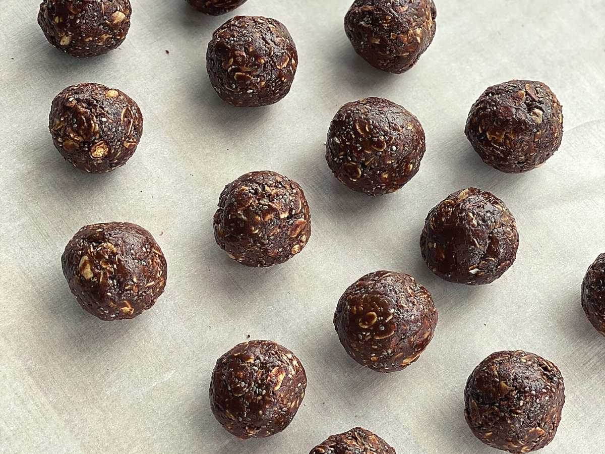 Hot honey chocolate balls in rows on parchment paper.