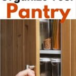 Hand opening an organized pantry with items in sealed storage containers showing.