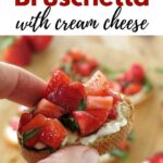 Hand holding strawberry bruschetta with cream cheese with title above it.