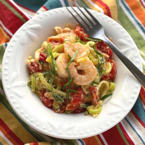Viral Tik Tok Baked Feta Zoodles and Shrimp in a bowl with a fork.