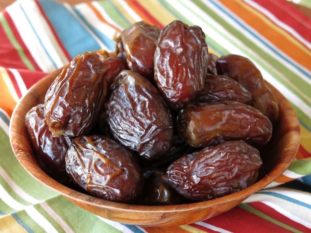 Bowl of Medjool Dates on a cloth napkin.