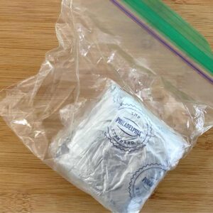 Wrapped cream cheese in sealed plastic bag with excess air removed.