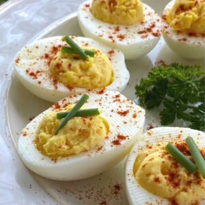 Keto deviled eggs in a semi-circle on a plate.