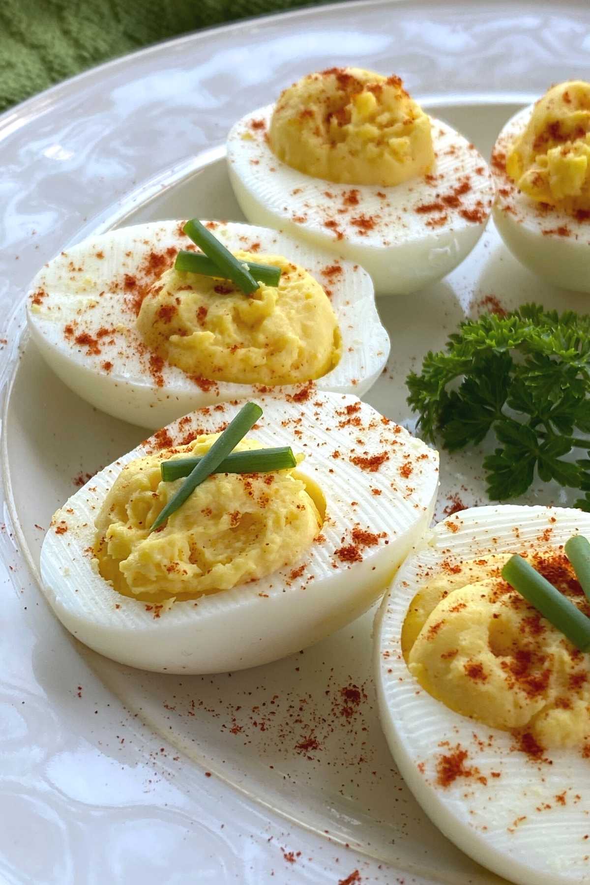 Keto deviled eggs in a semi-circle on a plate.