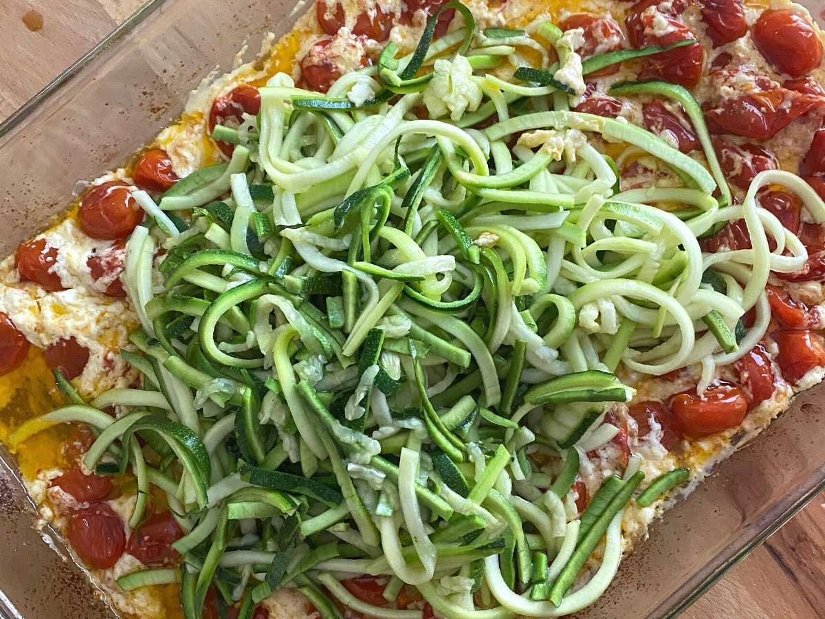 Spiralized Zucchini on top of cooked feta and tomatoes.
