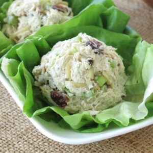 A scoop of chicken salad on a lettuce leaf.