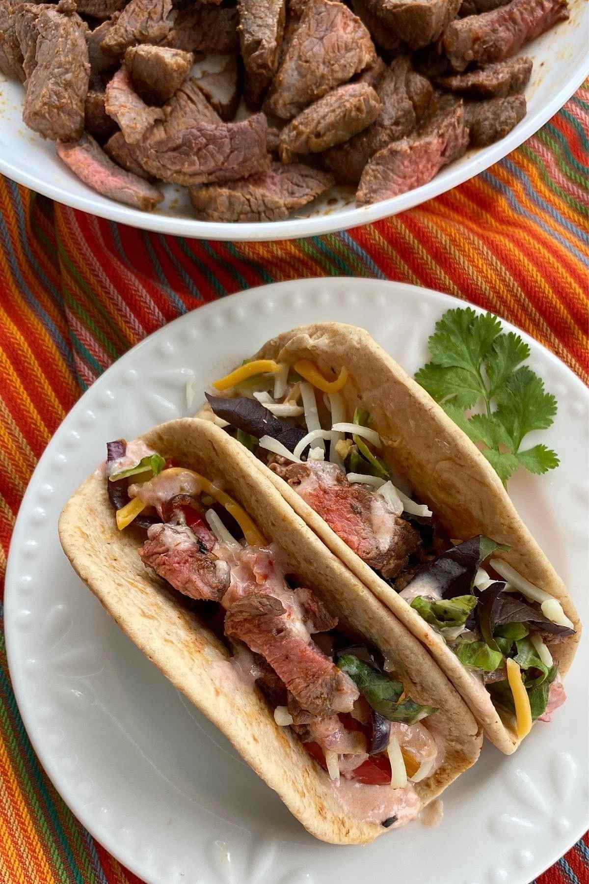 2 Beef Fajitas in low-carb flour tortillas on a plate.