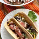 Air Fryer Steak Fajitas in flour tortillas on a plate.