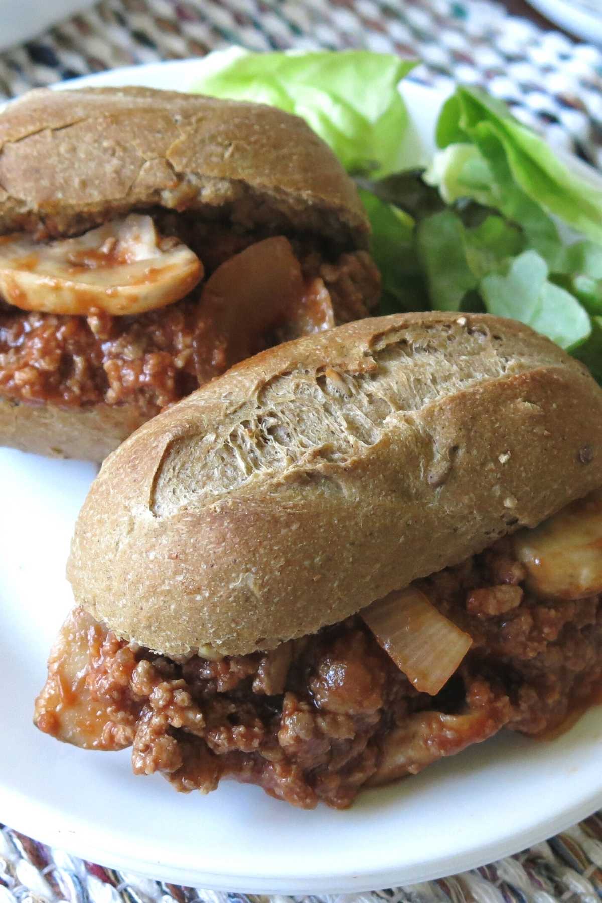 Gourmet sloppy joes in baguetts on a plate.