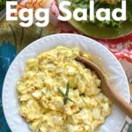 Keto egg salad in bowl with serving spoon.