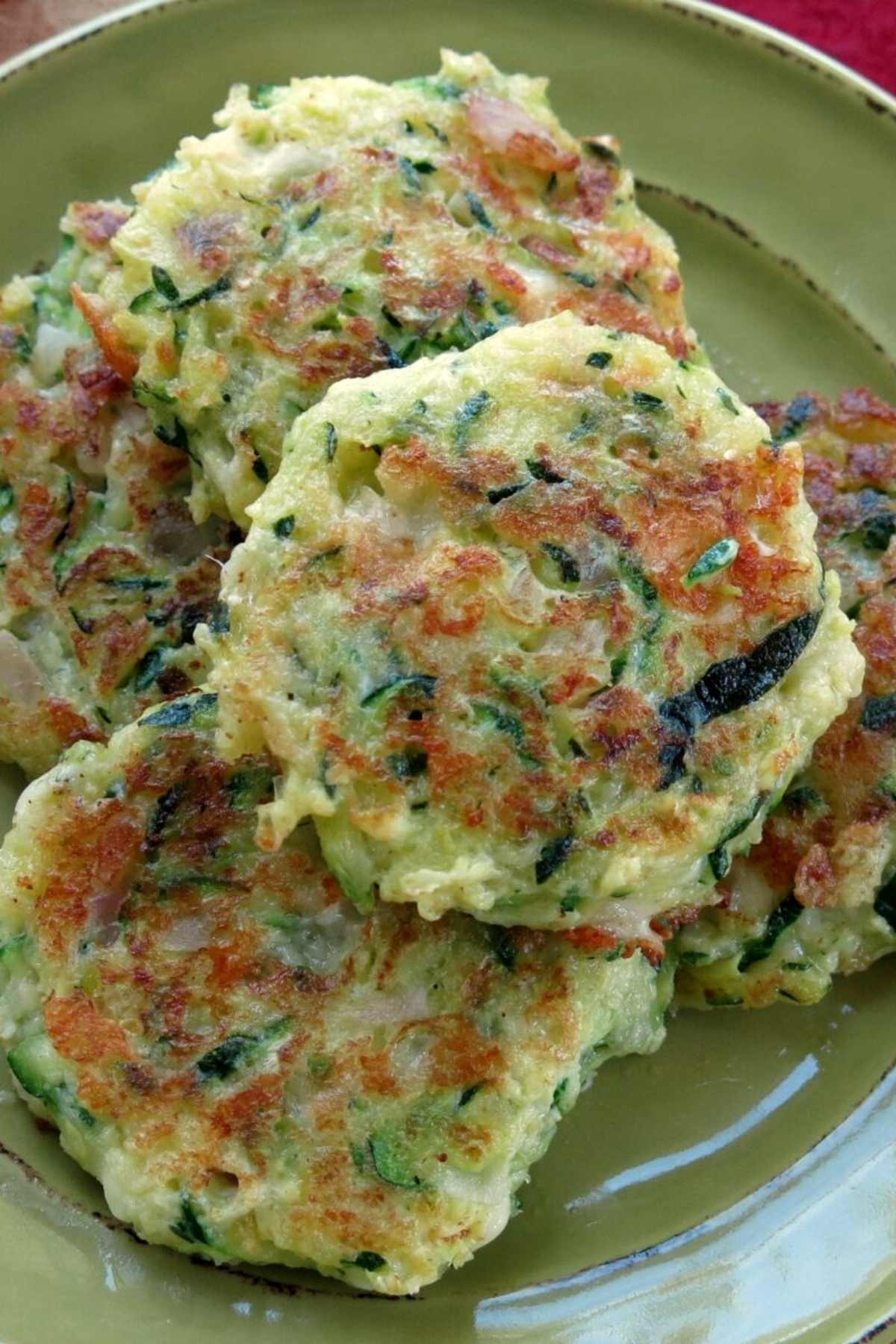 Healthy zucchini cakes piled on a plate.