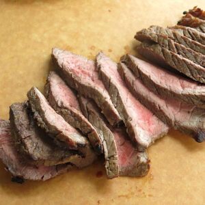 Sliced london broil on cutting board.