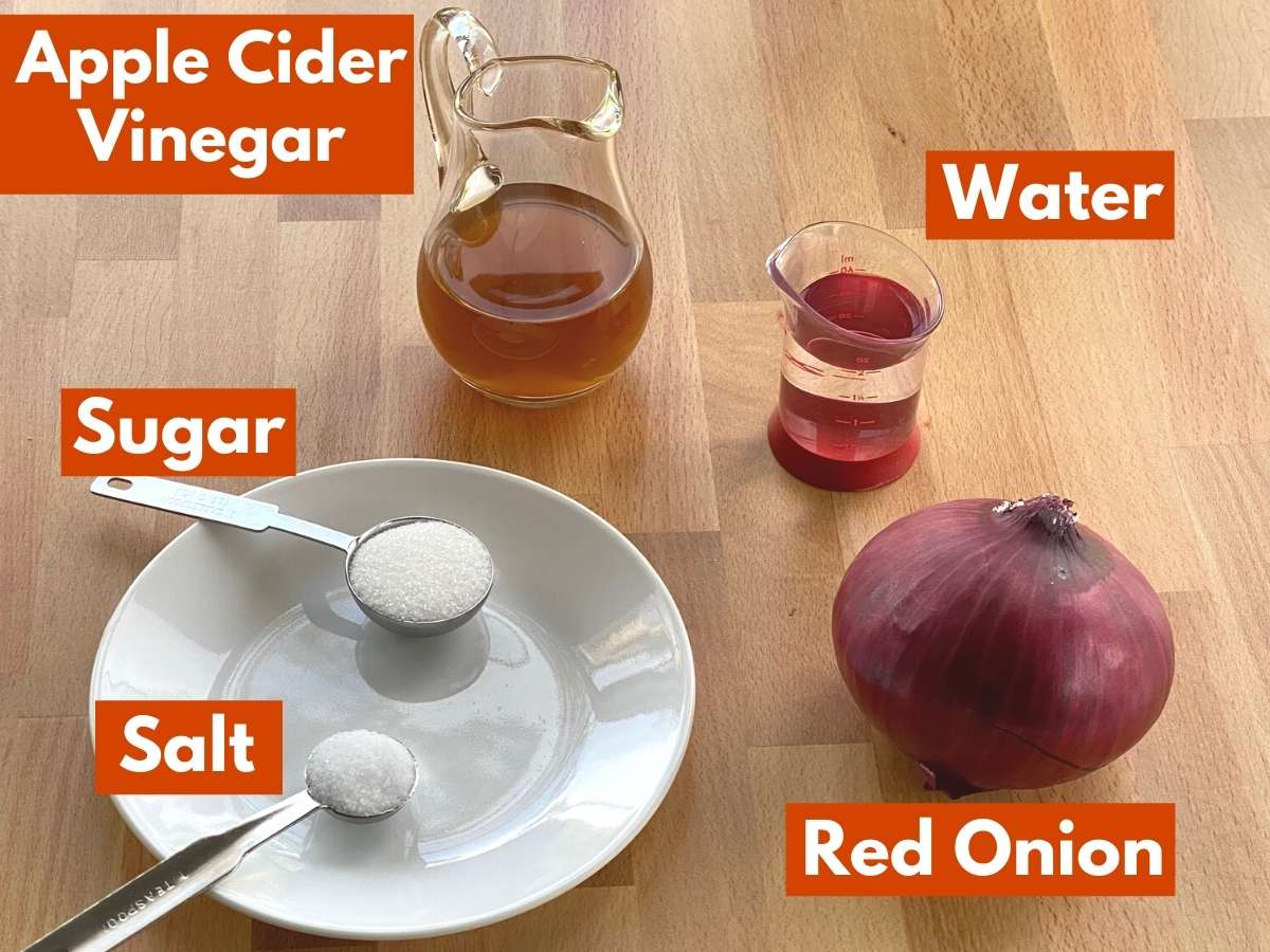 Ingredients with labels needed to make refrigerator pickled onions.