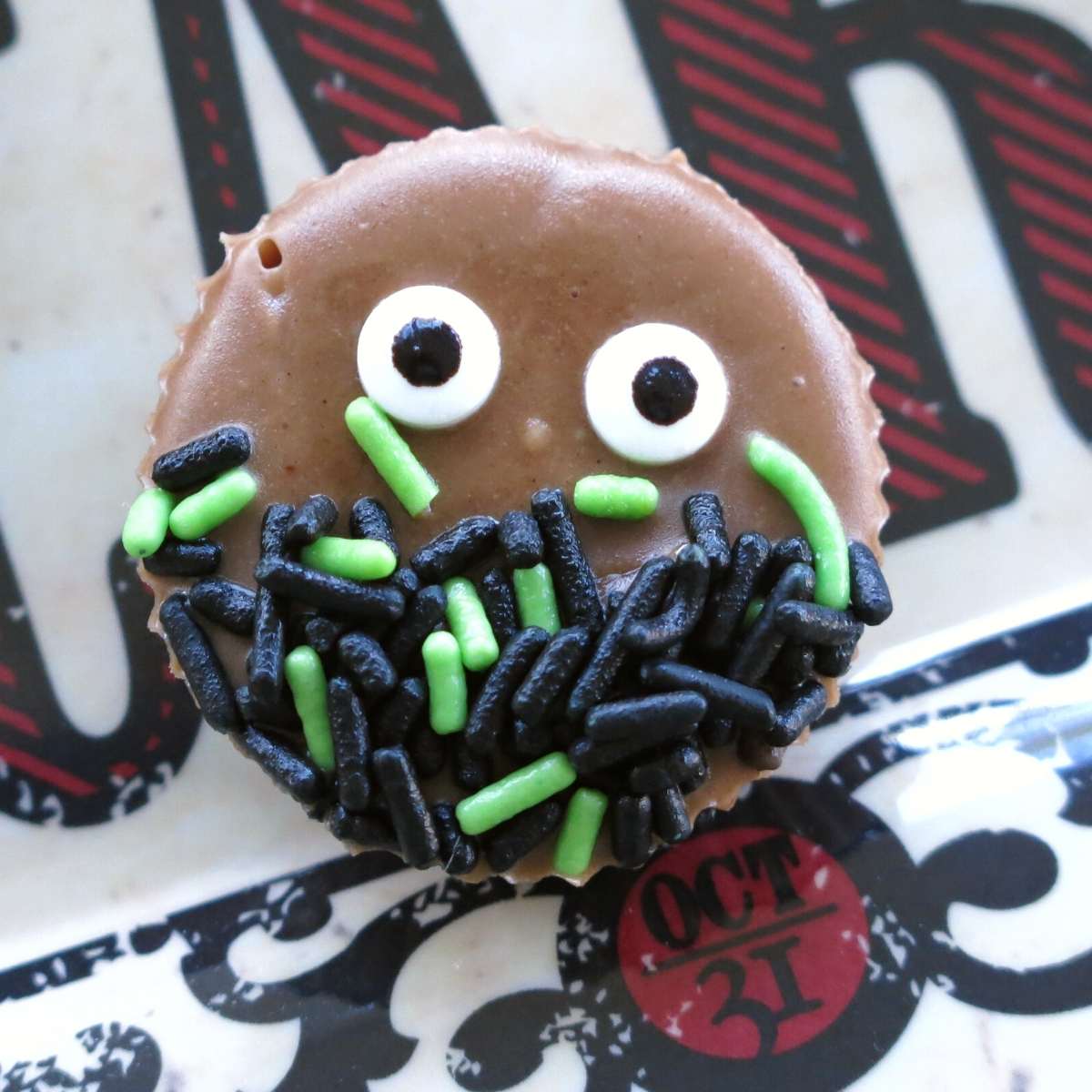 No-Bake Chocolate Halloween Fudge decorated with eyes and black and green sprinkles.