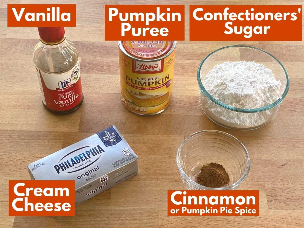 Labeled ingredients to make pumpkin dip: pumpkin puree, vanilla, confectioners' sugar, cream cheese, and cinnamon.