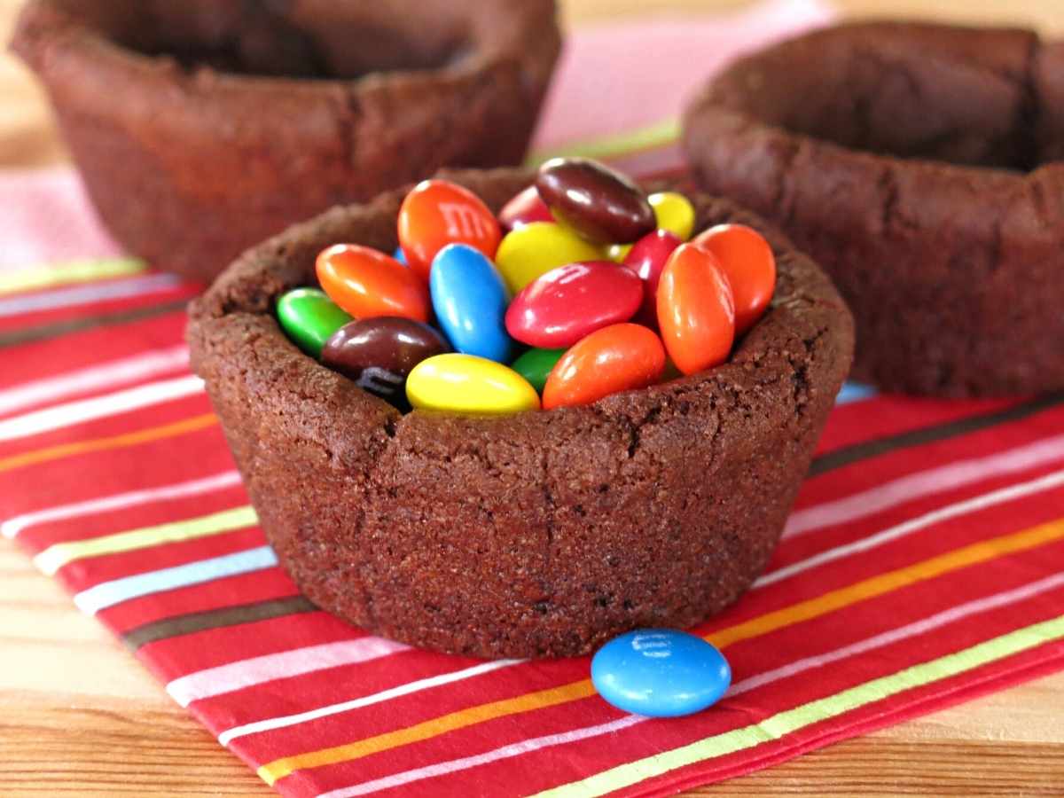 Vegan double chocolate cookie cup filled with candy.