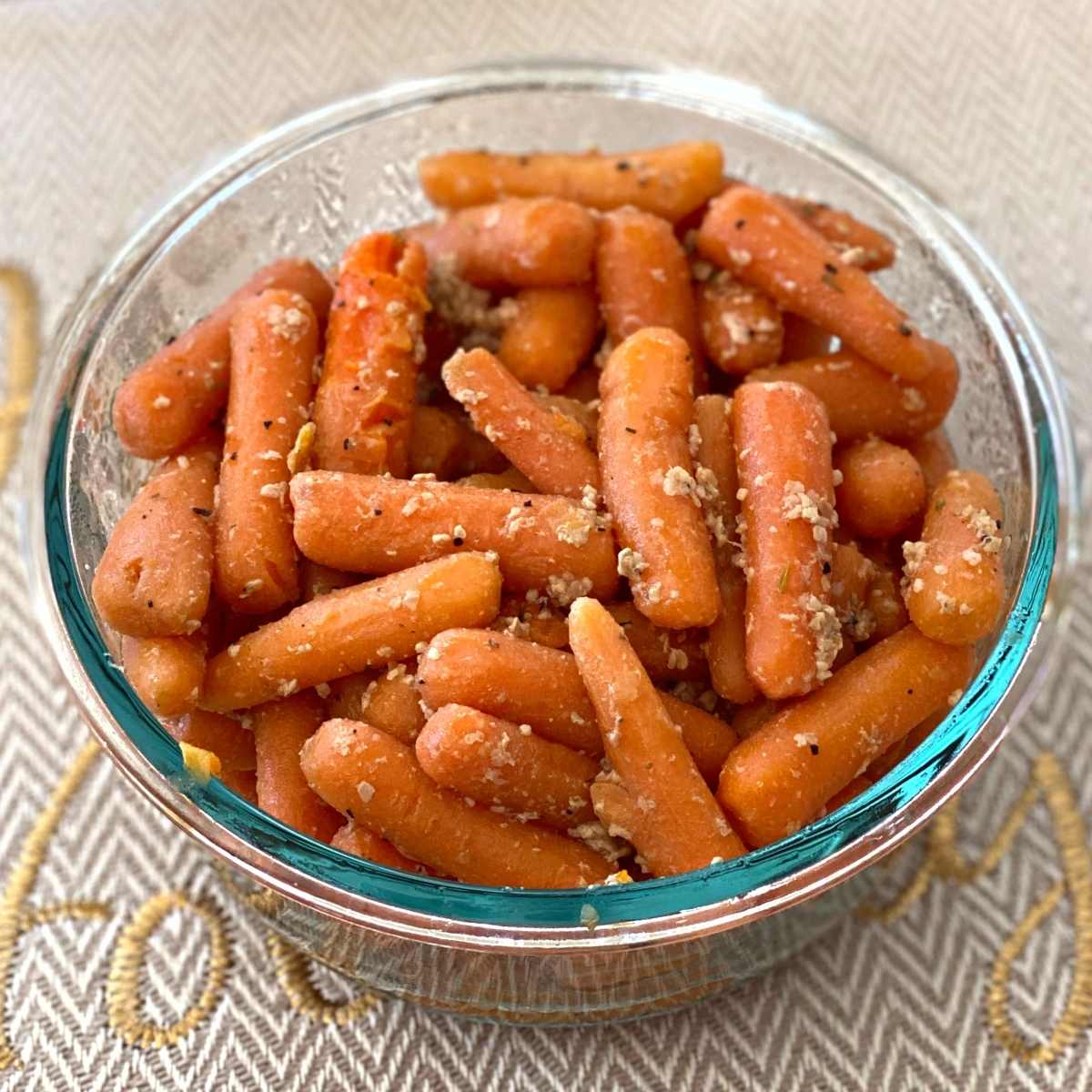 Garlic sauteéd baby carrots in a serving dish.